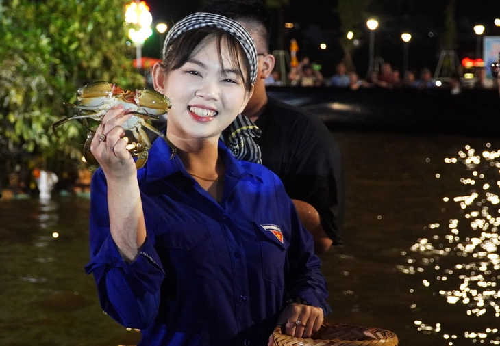 カマウ省で蟹を手にする女性