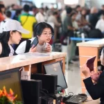 ベトナムの航空カウンターで搭乗手続きをおこなう乗客